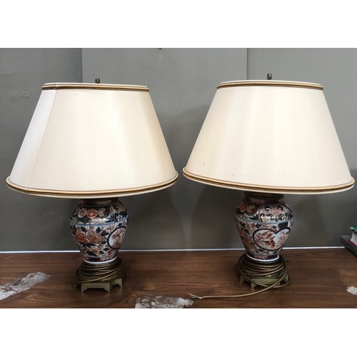 311 - A pair of gilt metal mounted Imari vase shaped table lamp of globular form painted in under glaze bl... 