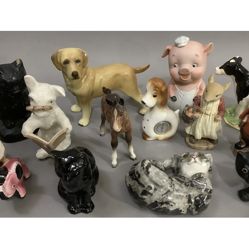 286 - A collection of mainly ceramic animals including dogs, cats, piggy bank, foal, etc