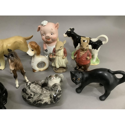 286 - A collection of mainly ceramic animals including dogs, cats, piggy bank, foal, etc