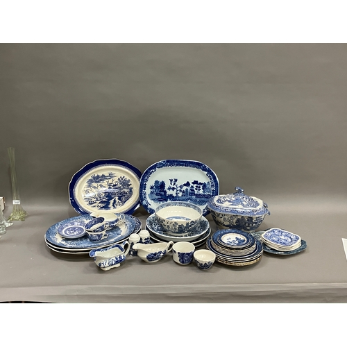 119 - A 19th century lidded willow pattern blue and white tureen with finial, together with other blue and... 