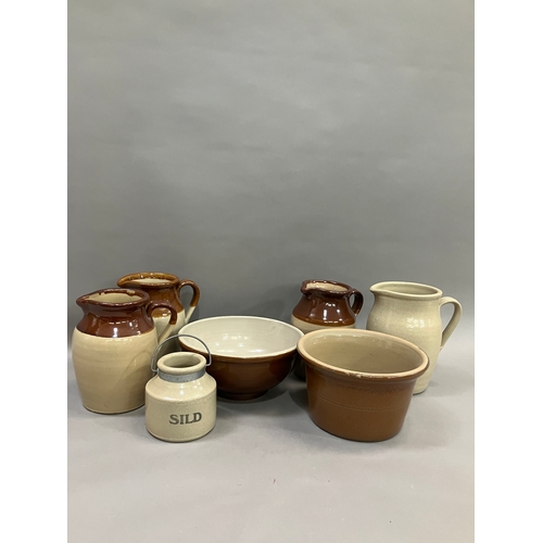 124 - Three stoneware jugs with brown half glaze together with stoneware bowls another jug and a jar marke... 