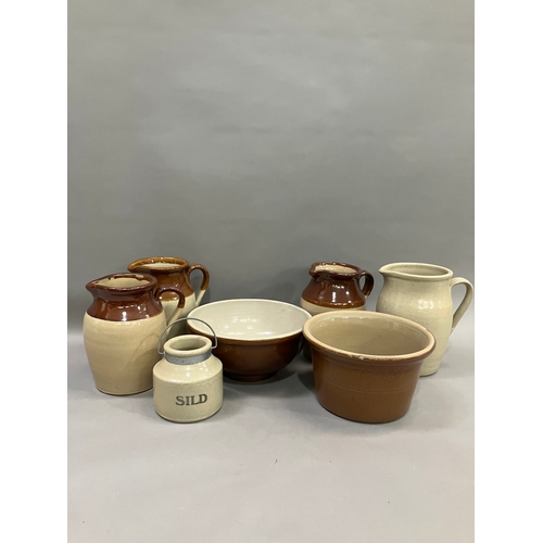 124 - Three stoneware jugs with brown half glaze together with stoneware bowls another jug and a jar marke... 