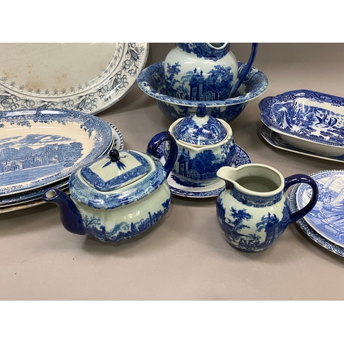 98 - A collection of blue and white ware including jugs, large bowls etc