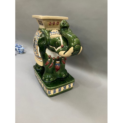 52 - A Chinese ceramic elephant glazed in green with trunk raised and standing on a rectangular plinth, 5... 