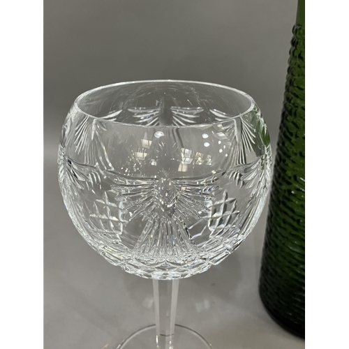 73 - A pair of Waterford cut glass wines on facetted stems, 20cm together with a vintage green glass wate... 