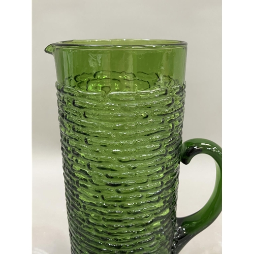 73 - A pair of Waterford cut glass wines on facetted stems, 20cm together with a vintage green glass wate... 