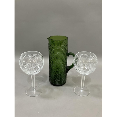 73 - A pair of Waterford cut glass wines on facetted stems, 20cm together with a vintage green glass wate... 