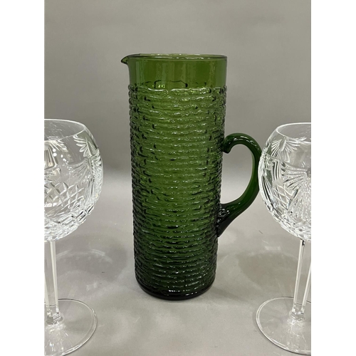 73 - A pair of Waterford cut glass wines on facetted stems, 20cm together with a vintage green glass wate... 