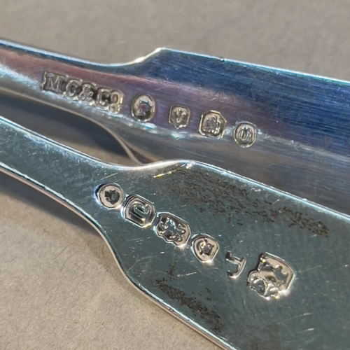 384 - Two Victorian silver fiddle and shell pattern mustard spoons, one engraved with crest 'Nobilis Ira',... 