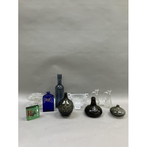 233 - A collection of glassware comprising two oil and vinegar bottles, a tall bottle shaped blue vase, a ... 