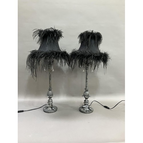 143 - A pair of chrome effect table lamps, the supports moulded as pineapples, on paw feet and having thre... 