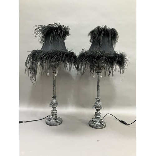 143 - A pair of chrome effect table lamps, the supports moulded as pineapples, on paw feet and having thre... 