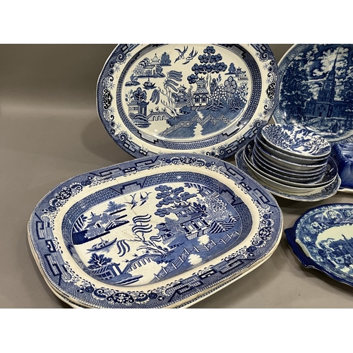 97 - A collection of blue and white ware including 19th century willow pattern plates, later wild rose pl... 