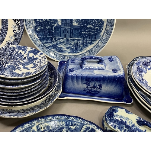 97 - A collection of blue and white ware including 19th century willow pattern plates, later wild rose pl... 