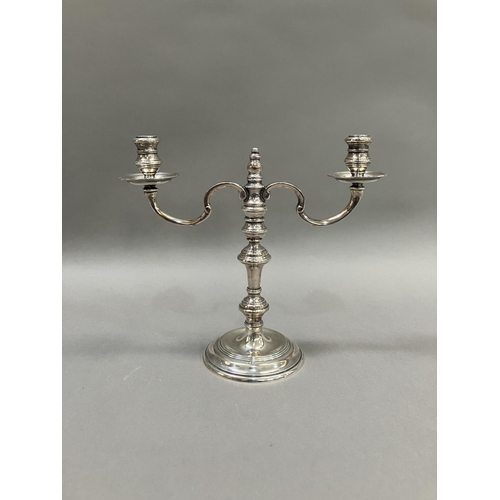 385 - An 18th century style silver two light candelabra with c-scroll arms and on a knopped column with di... 