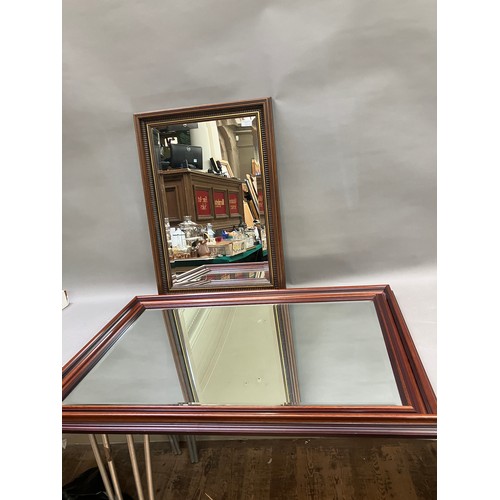 138 - Two wooden framed wall mirrors, largest measuring 73cm x 106cm