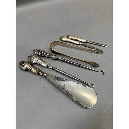 364 - Five silver handled dressing and manicure items including button hooks, shoe horn, file and cuticle ... 