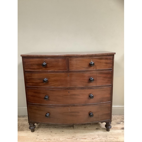 497 - A 19th century mahogany bow front chest of two short and three long graduated drawers on turned feet... 