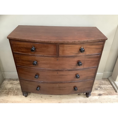 497 - A 19th century mahogany bow front chest of two short and three long graduated drawers on turned feet... 