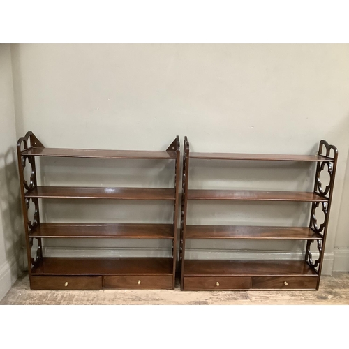 498 - A pair of mahogany reproduction wall shelves with cut sides, having four tiers with two drawers, 81c... 