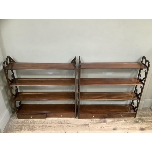 498 - A pair of mahogany reproduction wall shelves with cut sides, having four tiers with two drawers, 81c... 