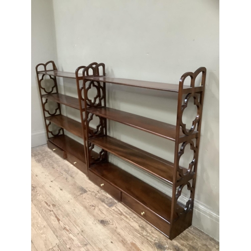 498 - A pair of mahogany reproduction wall shelves with cut sides, having four tiers with two drawers, 81c... 