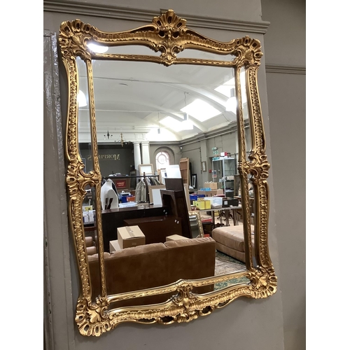 502 - A gilt framed rectangular wall mirror  having a shell and rocaille frame and inner slip, 109cm x 75c... 