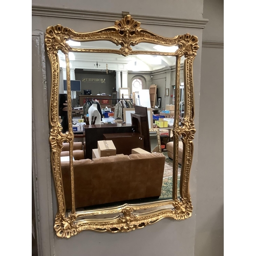 502 - A gilt framed rectangular wall mirror  having a shell and rocaille frame and inner slip, 109cm x 75c... 