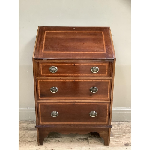 503 - An Edwardian mahogany inlaid fall front bureau with three graduated drawers, on bracket feet, oval s... 