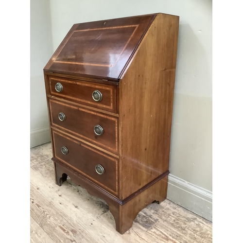 503 - An Edwardian mahogany inlaid fall front bureau with three graduated drawers, on bracket feet, oval s... 