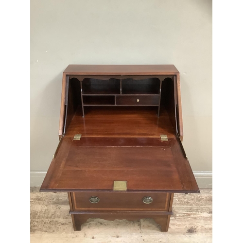 503 - An Edwardian mahogany inlaid fall front bureau with three graduated drawers, on bracket feet, oval s... 