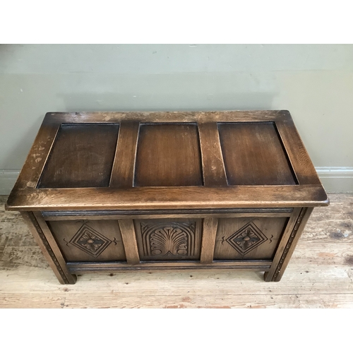 506 - A reproduction mahogany oak kist having a lift up top over triple indented panel on stile feet, 91cm... 