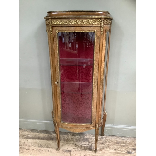 508 - A reproduction kingwood and metal mounted vitrine, bow fronted profile, having a single door and gla... 