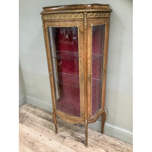 508 - A reproduction kingwood and metal mounted vitrine, bow fronted profile, having a single door and gla... 