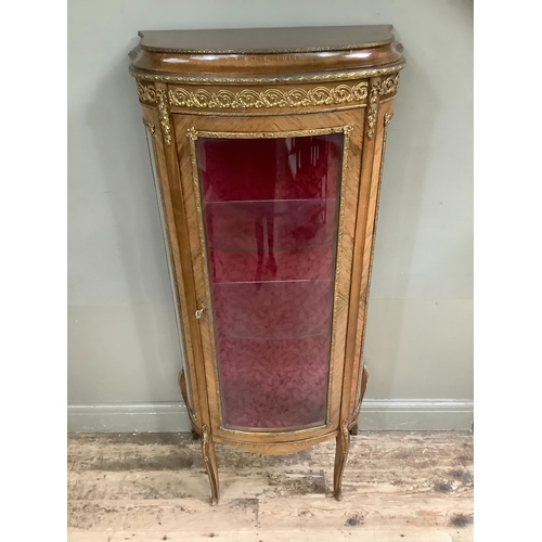 508 - A reproduction kingwood and metal mounted vitrine, bow fronted profile, having a single door and gla... 