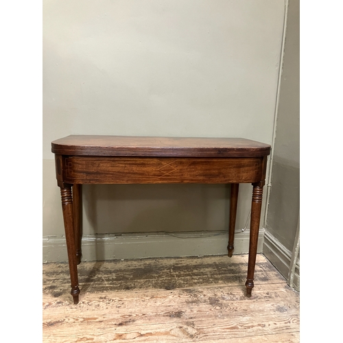 510 - A 19th century mahogany tea table, rectangular having a fold over top with boxwood inlay to the apro... 