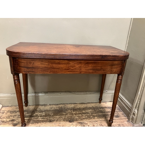 510 - A 19th century mahogany tea table, rectangular having a fold over top with boxwood inlay to the apro... 