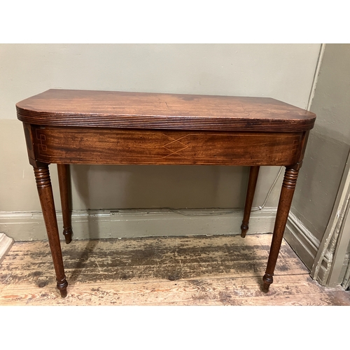 510 - A 19th century mahogany tea table, rectangular having a fold over top with boxwood inlay to the apro... 