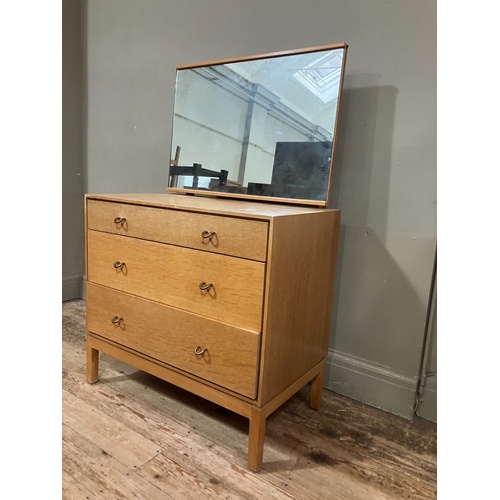 522 - A 1960s Stag pale oak dressing chest having an adjustable mirror over three graduated drawers, on sh... 