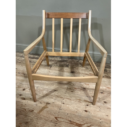 524 - A 1960/70s blond wood armchair with railed back and rounded legs, in need of webbing and reupholster... 