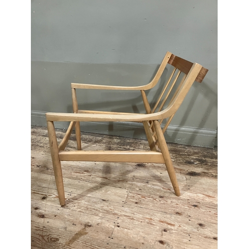 524 - A 1960/70s blond wood armchair with railed back and rounded legs, in need of webbing and reupholster... 