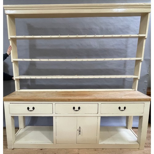 494 - A late 19th century estate painted and stripped pine dresser and rack having a moulded cornice above... 