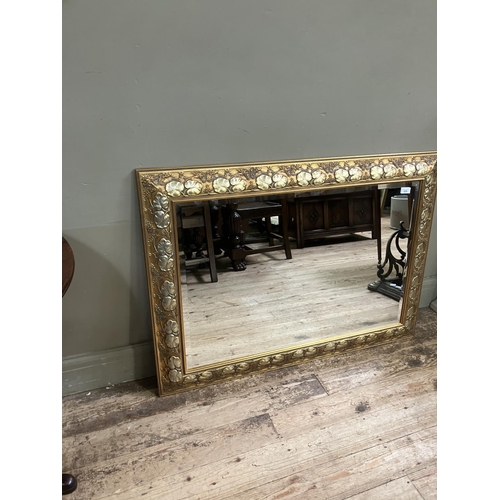 528 - A gilt framed wall mirror, rectangular, the frame moulded with plant forms, 80cm x 110cm