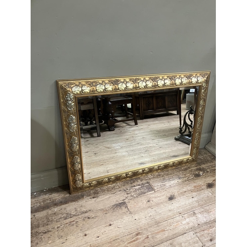 528 - A gilt framed wall mirror, rectangular, the frame moulded with plant forms, 80cm x 110cm