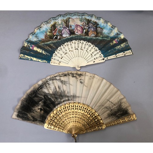 32 - Two mid-19th century fans, the first with carved and pierced wood sticks, painted in gold, the cream... 