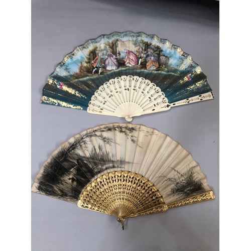 32 - Two mid-19th century fans, the first with carved and pierced wood sticks, painted in gold, the cream... 