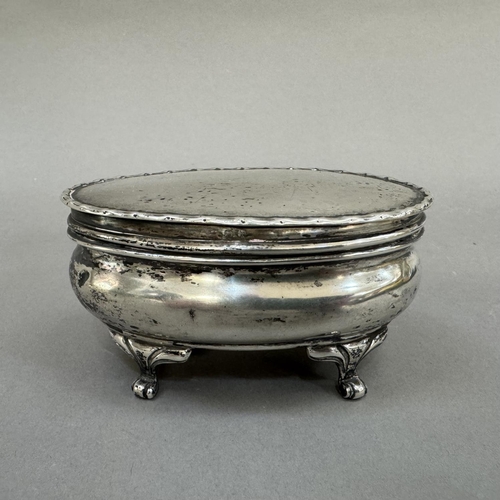 202 - An Edward VII silver dressing table box, Birmingham 1907, of oval outline, with hinged top with dimp... 