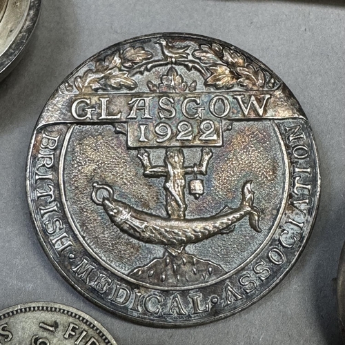 206 - A Girl Guide silver badge, c1928, pierced HGGS within a circular outline together with a British Med... 