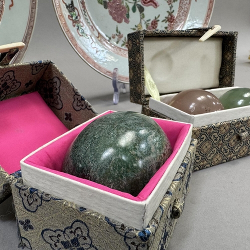 15 - A pair of early 20th century famille rose plates painted to the centre with rocks issuing peony and ... 