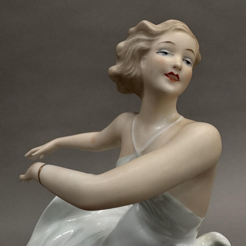 16 - A German china figure of a girl in dance pose, on circular base, 26.5cm high